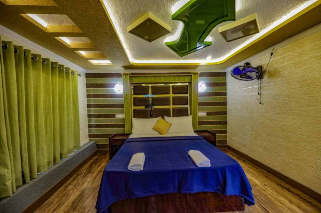 Premium air-conditioned bedroom with wooden flooring, accent lighting, and panoramic windows